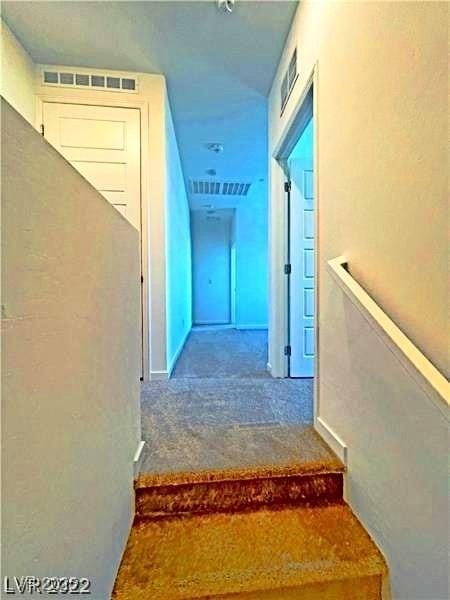staircase with visible vents and carpet