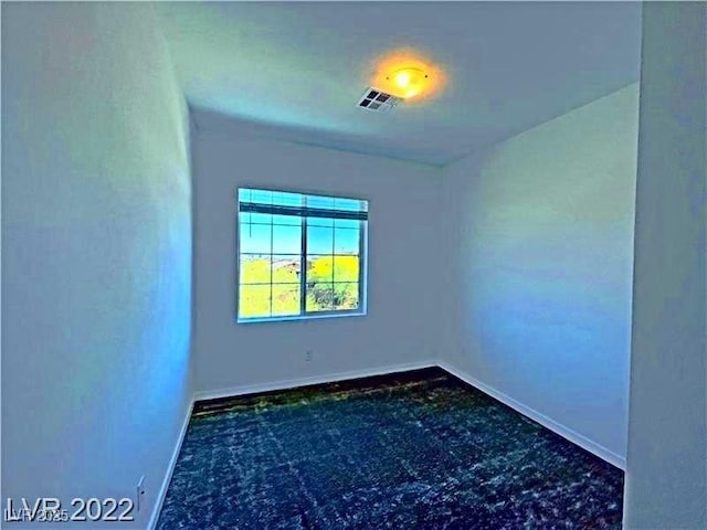 spare room featuring visible vents and baseboards