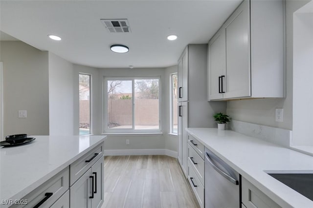 kitchen featuring visible vents, stainless steel dishwasher, recessed lighting, and baseboards