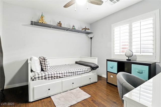 bedroom featuring a ceiling fan, baseboards, visible vents, and wood finished floors
