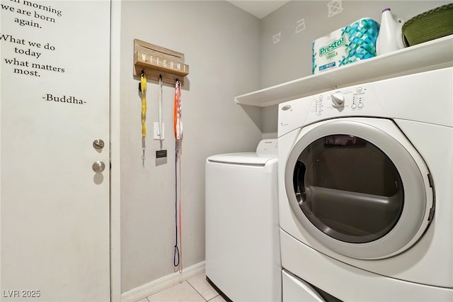 laundry area featuring laundry area, baseboards, light tile patterned floors, and washing machine and dryer
