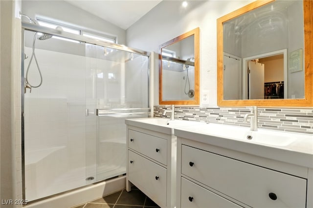 bathroom featuring vanity, tasteful backsplash, and a shower stall