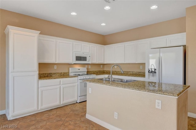 8988 Winchester Ridge St, Las Vegas, NV 89139 - kitchen with white cabinets, white appliances, a center island with sink, and a sink