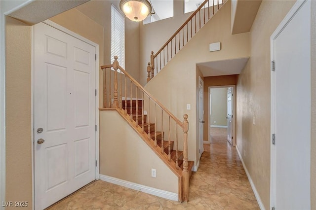 8988 Winchester Ridge St, Las Vegas, NV 89139 - entrance foyer featuring stairway, a towering ceiling, and baseboards