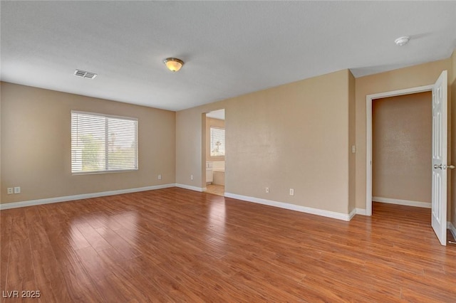 8988 Winchester Ridge St, Las Vegas, NV 89139 - empty room with visible vents, light wood-style flooring, and baseboards