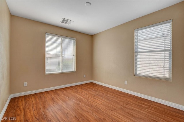 8988 Winchester Ridge St, Las Vegas, NV 89139 - empty room featuring visible vents, wood finished floors, and baseboards