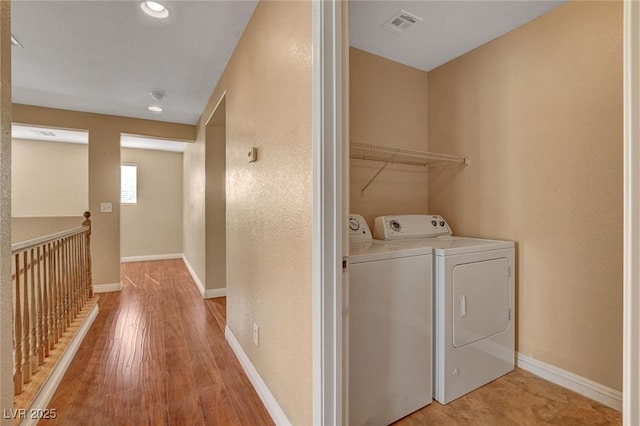 8988 Winchester Ridge St, Las Vegas, NV 89139 - laundry area featuring visible vents, light wood-style floors, baseboards, washer and dryer, and laundry area