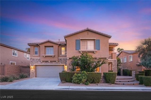 1265 Vietti St, Henderson, NV 89012 - mediterranean / spanish house with stone siding, driveway, stucco siding, a tile roof, and an attached garage