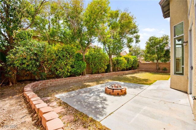 view of yard featuring a fenced backyard, a patio area, and an outdoor fire pit