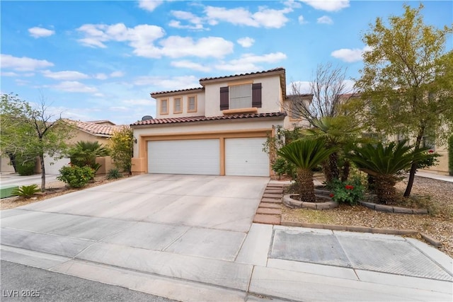 mediterranean / spanish-style house featuring concrete driveway, an attached garage, a tile roof, and stucco siding