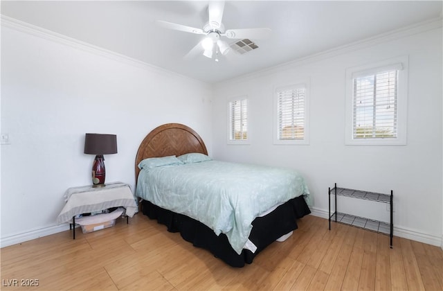 bedroom with crown molding, baseboards, multiple windows, and light wood-type flooring