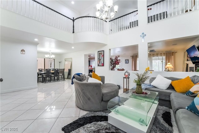 tiled living room with recessed lighting, a high ceiling, a chandelier, and baseboards