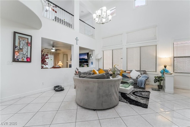 living area with baseboards, a high ceiling, and a wealth of natural light