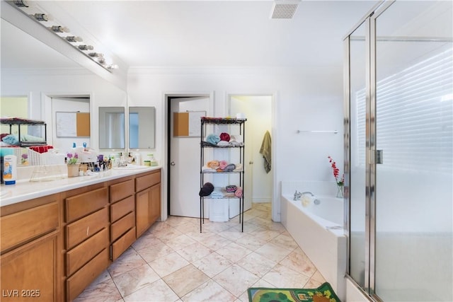 bathroom featuring crown molding, a shower with shower door, double vanity, visible vents, and a bath