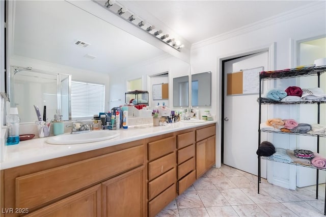 full bath featuring visible vents, ornamental molding, a sink, and marble finish floor