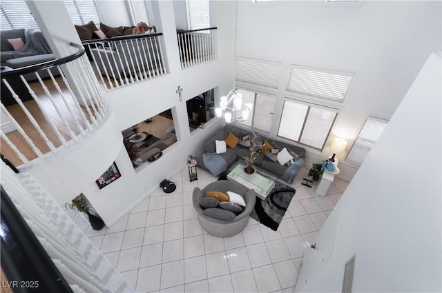 living area with a high ceiling and tile patterned floors