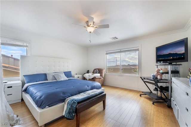 bedroom with ceiling fan, visible vents, multiple windows, and light wood-type flooring
