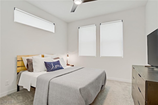 bedroom with light carpet, baseboards, and ceiling fan