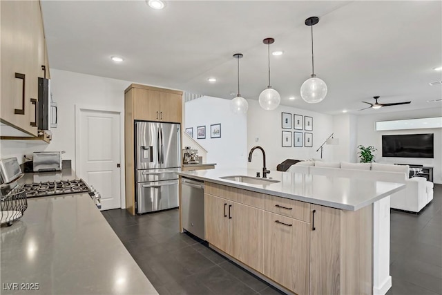 kitchen featuring a sink, stainless steel appliances, recessed lighting, light brown cabinetry, and light countertops