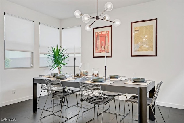 dining room featuring a wealth of natural light, baseboards, and a notable chandelier