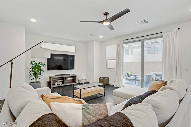 living area featuring baseboards, a ceiling fan, visible vents, and recessed lighting