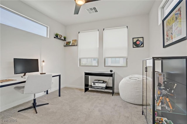 office area with carpet, visible vents, baseboards, and a ceiling fan