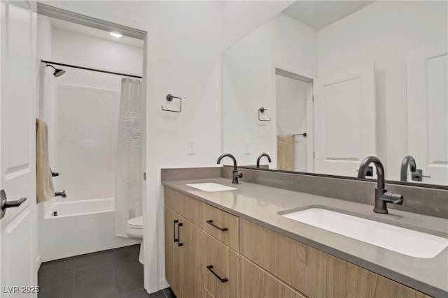 bathroom featuring a sink, tile patterned flooring, toilet, and double vanity