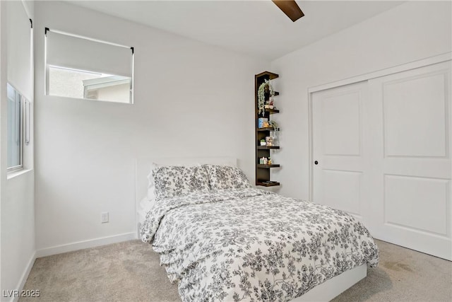 carpeted bedroom featuring baseboards, a closet, and a ceiling fan