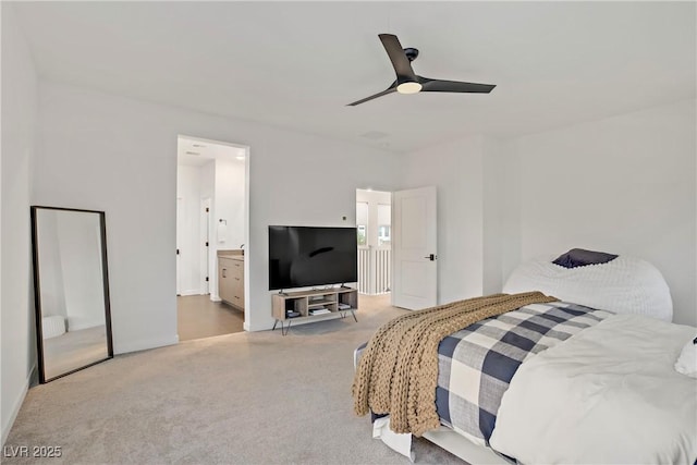carpeted bedroom with ensuite bathroom and ceiling fan