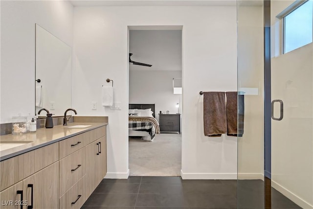 full bath with connected bathroom, double vanity, a sink, a shower with shower door, and tile patterned floors
