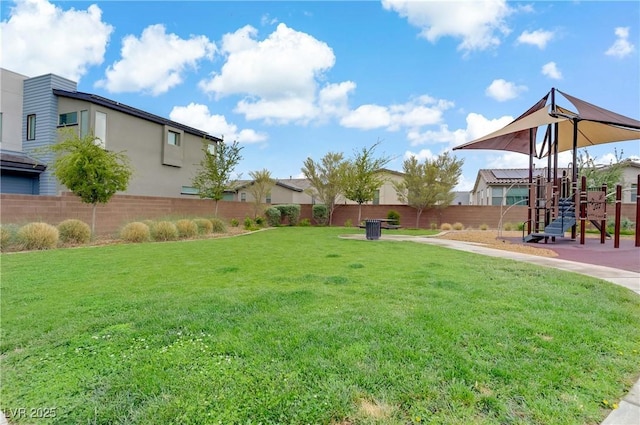 view of yard featuring fence and a playground