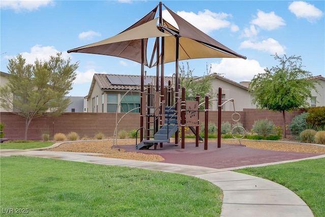 community playground featuring a yard and fence