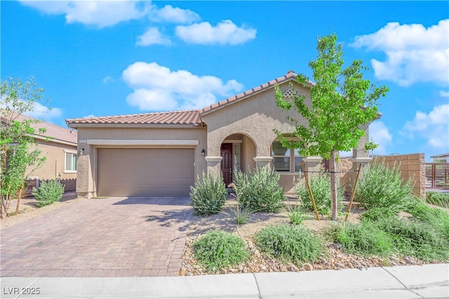 9590 Smiley Creek St, Las Vegas, NV 89178 - mediterranean / spanish house with stucco siding, a garage, decorative driveway, and a tile roof