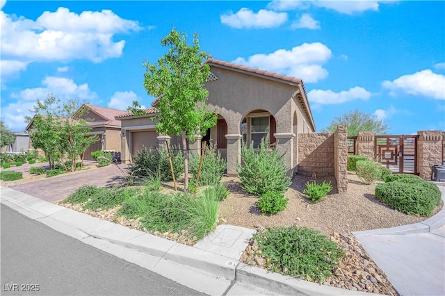 9590 Smiley Creek St, Las Vegas, NV 89178 - view of front of property with fence, stucco siding, a tiled roof, and an attached garage