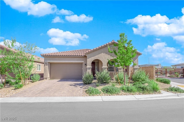 9590 Smiley Creek St, Las Vegas, NV 89178 - mediterranean / spanish house with stucco siding, driveway, a tiled roof, an attached garage, and fence