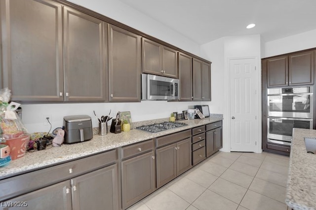 9590 Smiley Creek St, Las Vegas, NV 89178 - kitchen featuring recessed lighting, light tile patterned flooring, dark brown cabinets, and appliances with stainless steel finishes