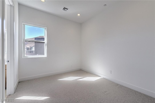 carpeted empty room featuring visible vents, recessed lighting, and baseboards