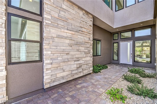 entrance to property with stucco siding