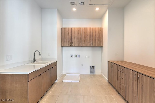 laundry room featuring hookup for a gas dryer, visible vents, cabinet space, and a sink