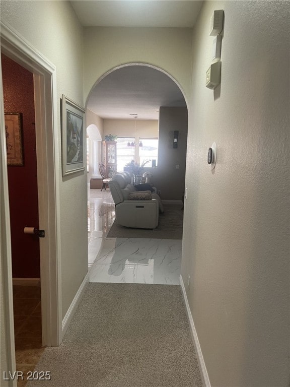 6596 Secluded Ave, Las Vegas, NV 89110 - hallway with arched walkways, marble finish flooring, and baseboards