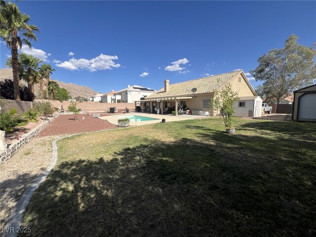 6596 Secluded Ave, Las Vegas, NV 89110 - view of yard featuring a patio and a storage unit