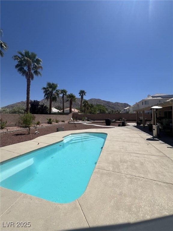 6596 Secluded Ave, Las Vegas, NV 89110 - outdoor pool featuring a mountain view, a fenced backyard, and a patio area