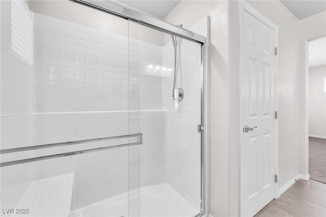9198 Rolling Sky Dr, Las Vegas, NV 89178 - bathroom featuring a stall shower, baseboards, and tile patterned flooring