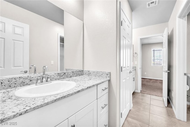 9198 Rolling Sky Dr, Las Vegas, NV 89178 - bathroom with tile patterned floors, vanity, baseboards, and toilet
