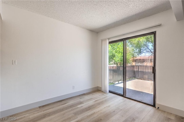 250 Shadybrook Ln Unit D, Las Vegas, NV 89107 - empty room with a textured ceiling, light wood-style floors, and baseboards