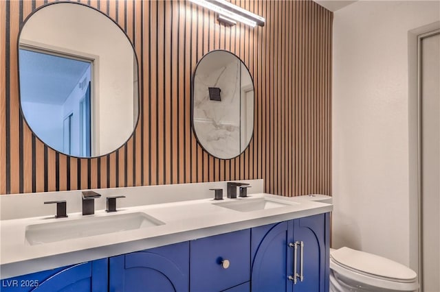 250 Shadybrook Ln Unit D, Las Vegas, NV 89107 - full bathroom with wallpapered walls, toilet, and double vanity
