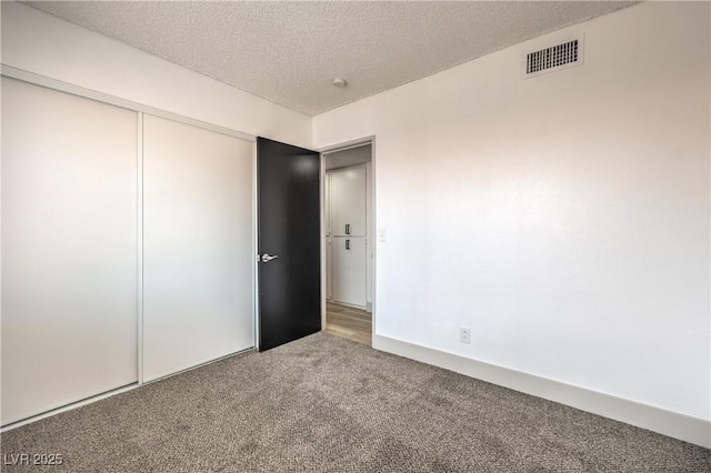 250 Shadybrook Ln Unit D, Las Vegas, NV 89107 - unfurnished bedroom featuring carpet floors, a textured ceiling, and a closet