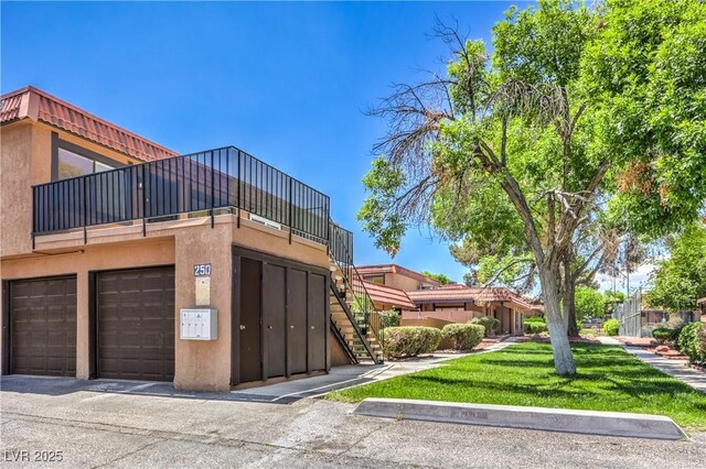 250 Shadybrook Ln Unit D, Las Vegas, NV 89107 - view of property featuring stairs and a garage
