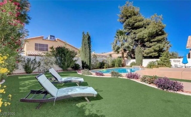 view of community with a yard and a fenced backyard