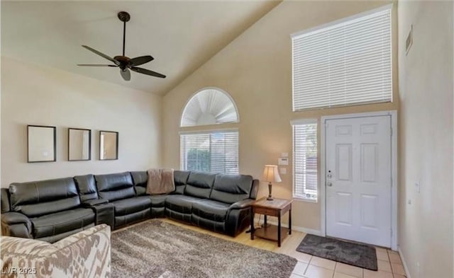 living room with light tile patterned flooring, high vaulted ceiling, a ceiling fan, visible vents, and baseboards